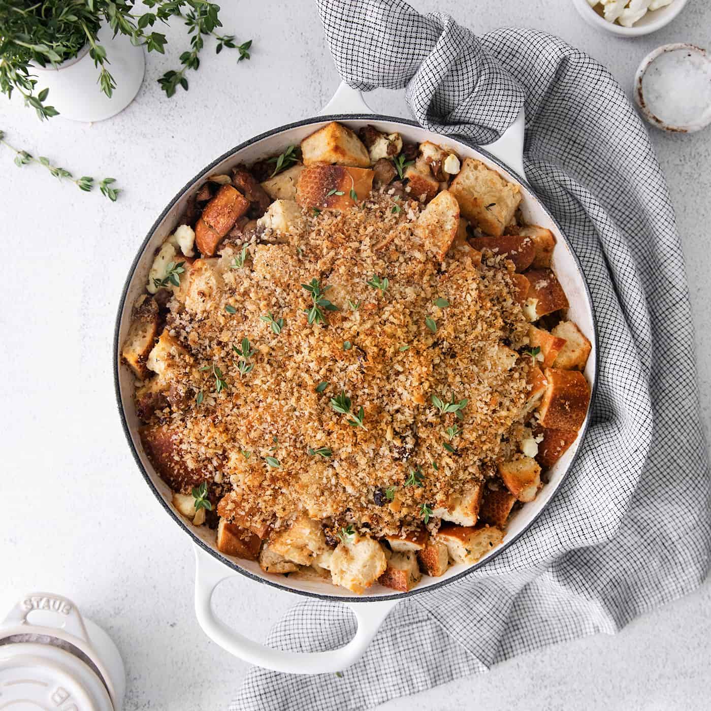 This savory dressing with mushrooms, pork sausage, crispy garlic breadcrumbs, and Parmesan is the best Thanksgiving stuffing recipe! Overhead view of roasted garlic mushroom dressing
