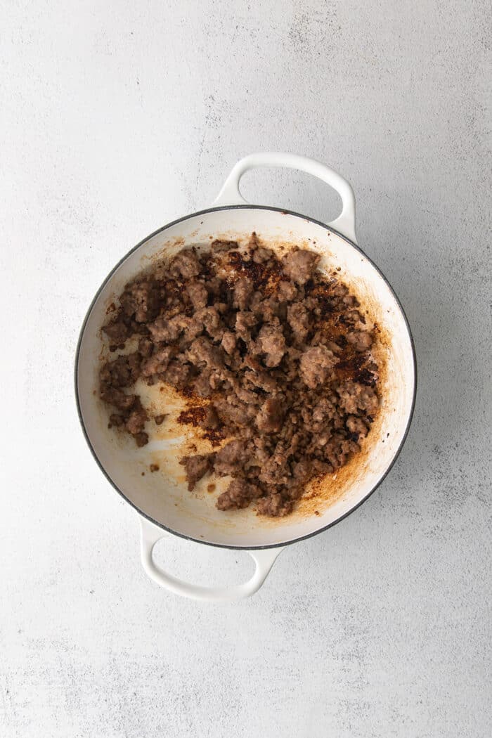 This savory dressing with mushrooms, pork sausage, crispy garlic breadcrumbs, and Parmesan is the best Thanksgiving stuffing recipe! Sausage in a white bowl