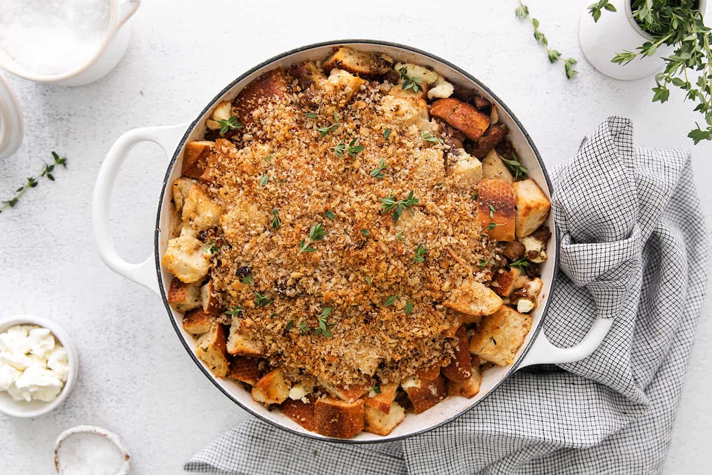 This savory dressing with mushrooms, pork sausage, crispy garlic breadcrumbs, and Parmesan is the best Thanksgiving stuffing recipe! Overhead view of mushroom sausage dressing in a casserole dish.