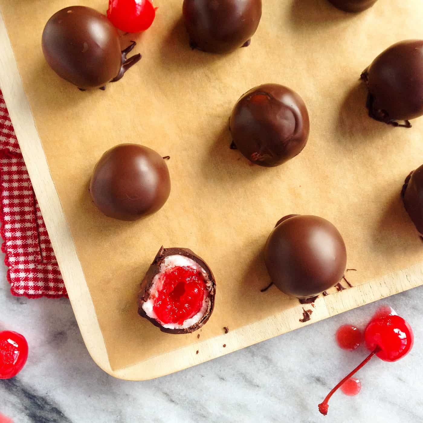 Cherry Cordials are surprisingly easy to make and so much better than store-bought! A sweet, fun treat that’s perfect for sharing. Cherry cordials on a baking sheet