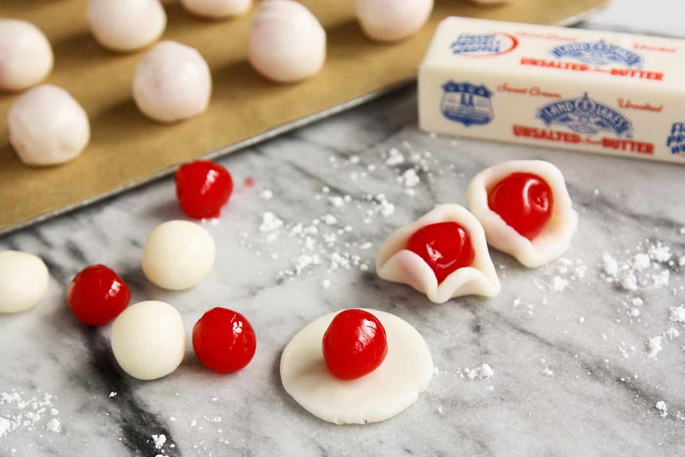 Sweet and tart, these Chocolate Covered Cherry Cordials are fun to create, even better to eat and add joy to any holiday platter. Maraschino cherries being wrapped in dough