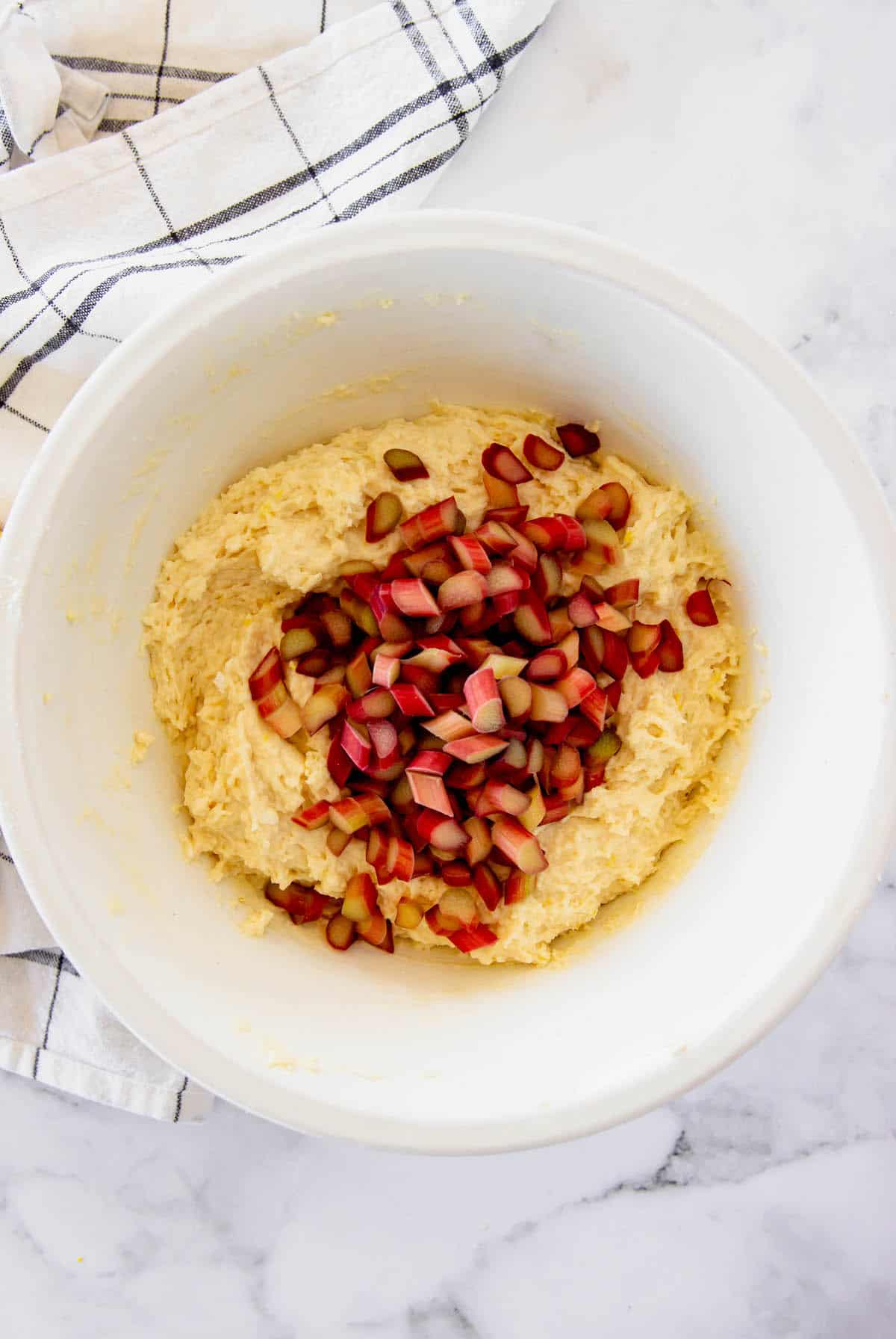 These rhubarb scones are moist inside and flaky outside, filled with juicy tart rhubarb and fresh lemon zest. Perfect with coffee or tea! Lemon scone batter with chopped rhubarb pieces