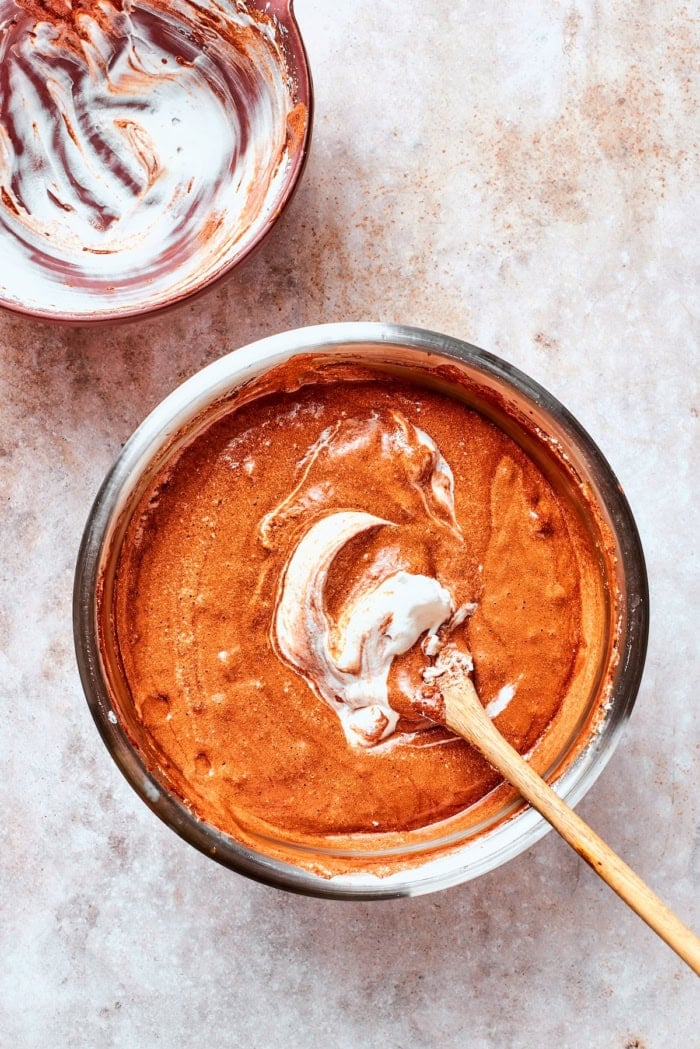 These decadent and delicious Chocolate Mousse Cups are the perfect personal-sized dessert! Serve them at a party and they’ll disappear FAST. Folding chocolate and egg white mixture together in bowl.