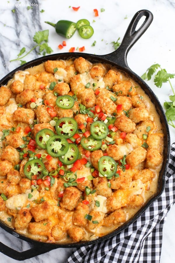 tater tot hotdish with jalapeƱos in a cast iron skillet