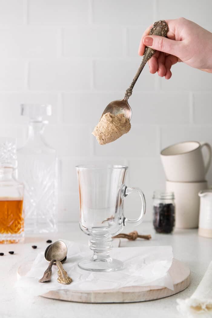 A spoon dropped spiced butter into a glass