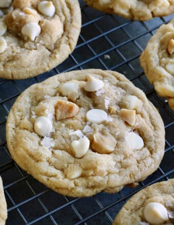 White chocolate macadamia nut cookies on a cooling rack