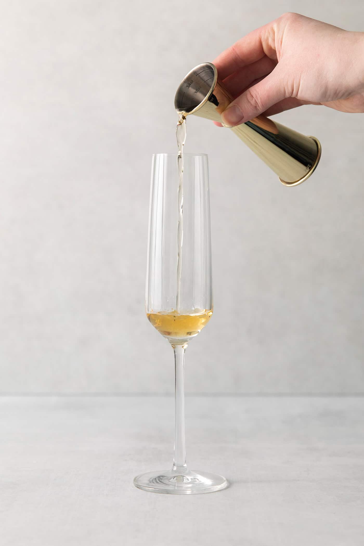 This Blood Orange Mimosa with St. Germain is bursting with fresh, bright flavor. It's super simple to make and the gorgeous color! St Germain being poured into a champagne flute