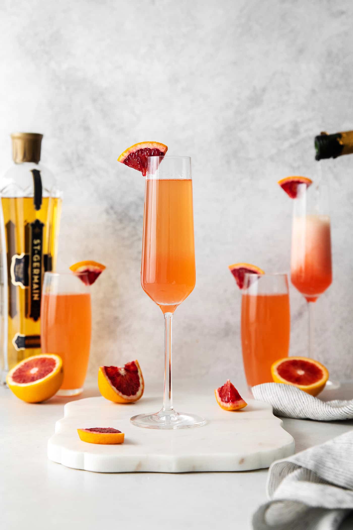 This Blood Orange Mimosa with St. Germain is bursting with fresh, bright flavor. It's super simple to make and the gorgeous color! Blood orange mimosas in champagne flutes