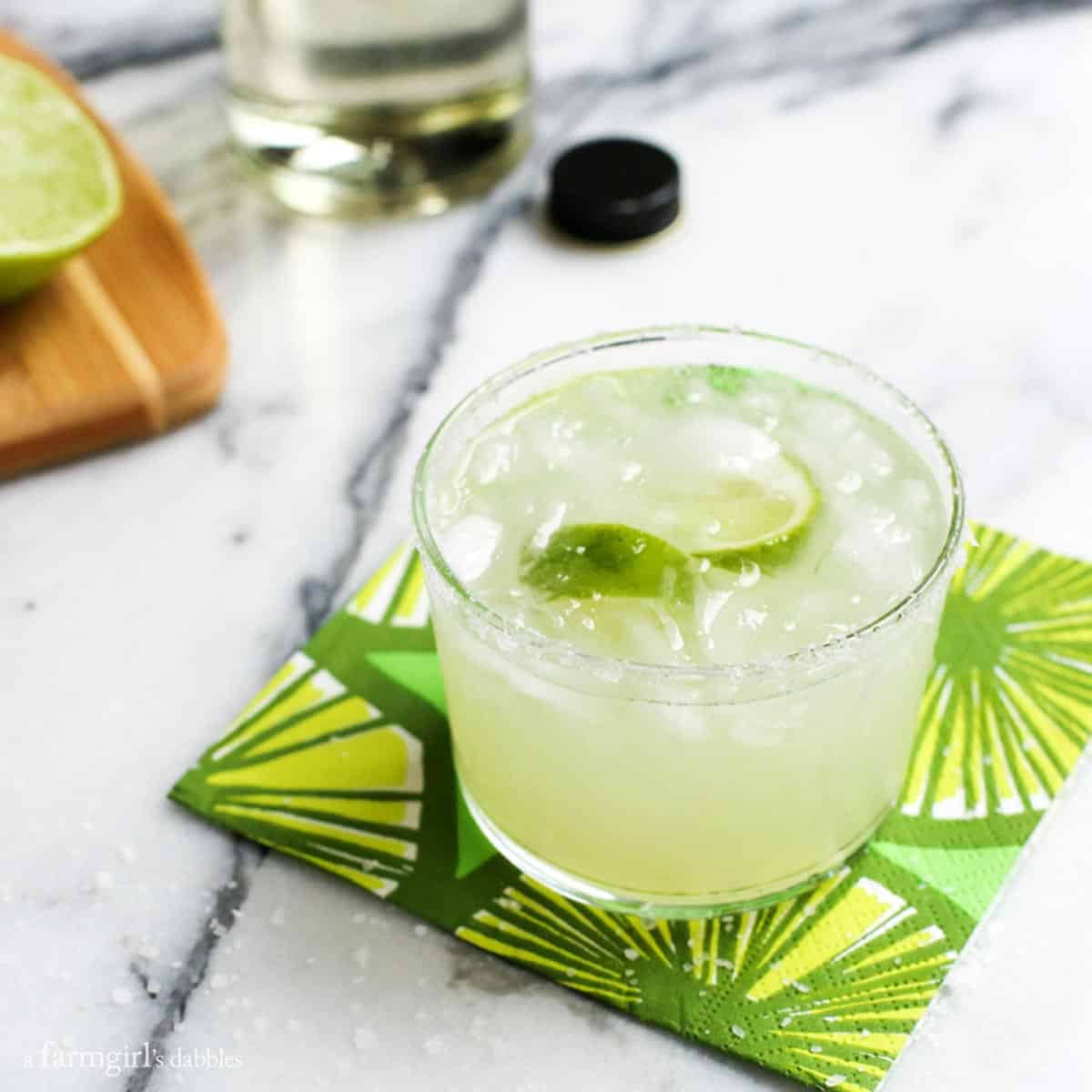 This Classic Margarita Recipe is the only one you'll ever need, whether you want a single drink or a pitcher to share. Margaritas on a lime napkin