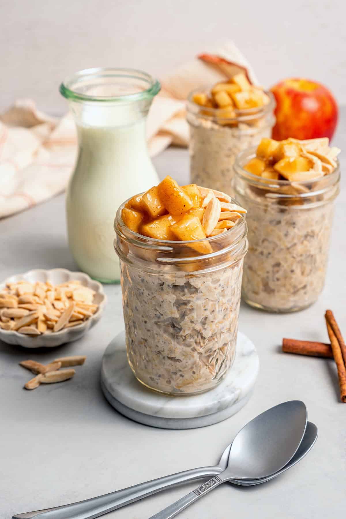 This Apple Cinnamon Overnight Oats recipe is an easy make-ahead breakfast, with the creamiest oats and lots of cozy, tender apples! 3 jars of overnight oats topped with cinnamon apples