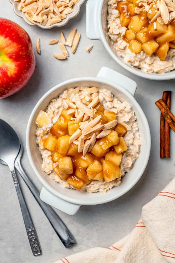 This Apple Cinnamon Overnight Oats recipe is an easy make-ahead breakfast, with the creamiest oats and lots of cozy, tender apples! Overhead view of apple cinnamon overnight oats in bowl with slivered almonds on top