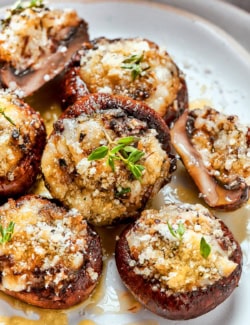 Closeup of cheesy stuffed mushrooms on plate