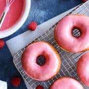 Glazed donuts on a wire rack.