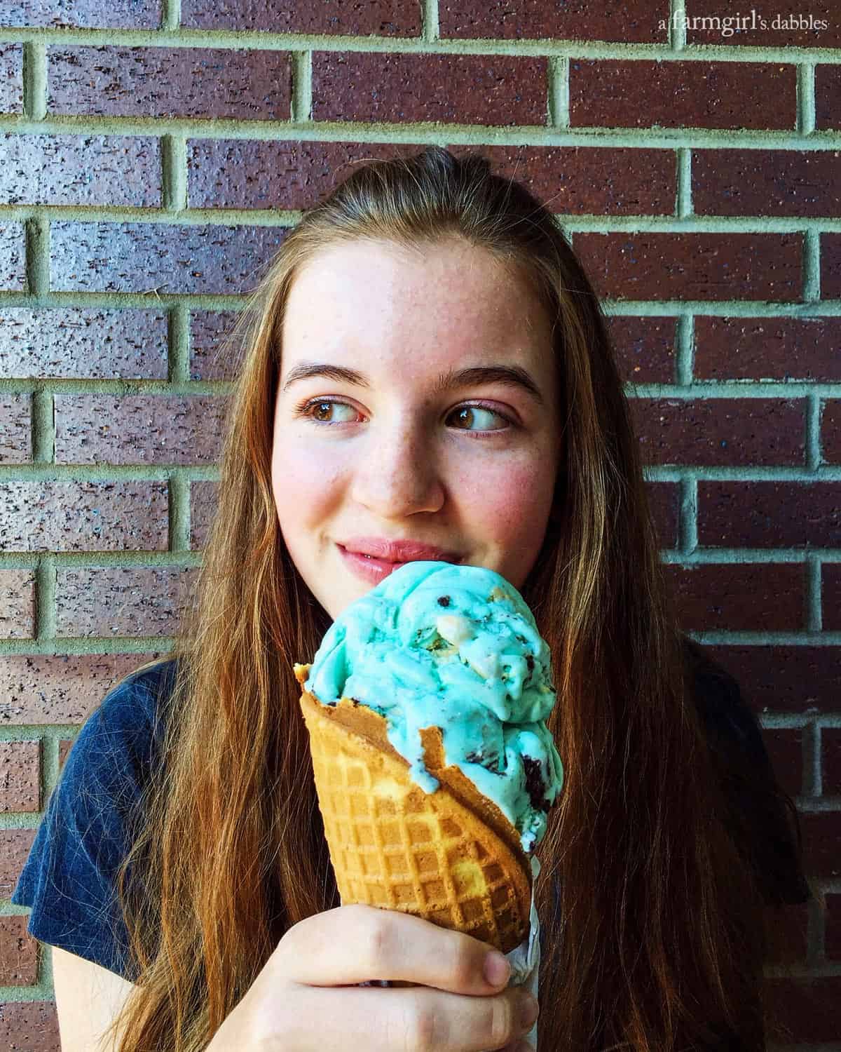 a girl holding an ice cream cone
