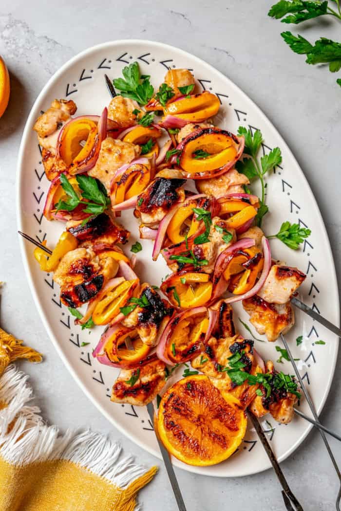 Bold, smoky chipotle meets the sweet flavor of orange in these easy Turkey Kabobs. This recipe is a summer staple in my home! Overhead view of grilled chipotle orange turkey kabobs on platter