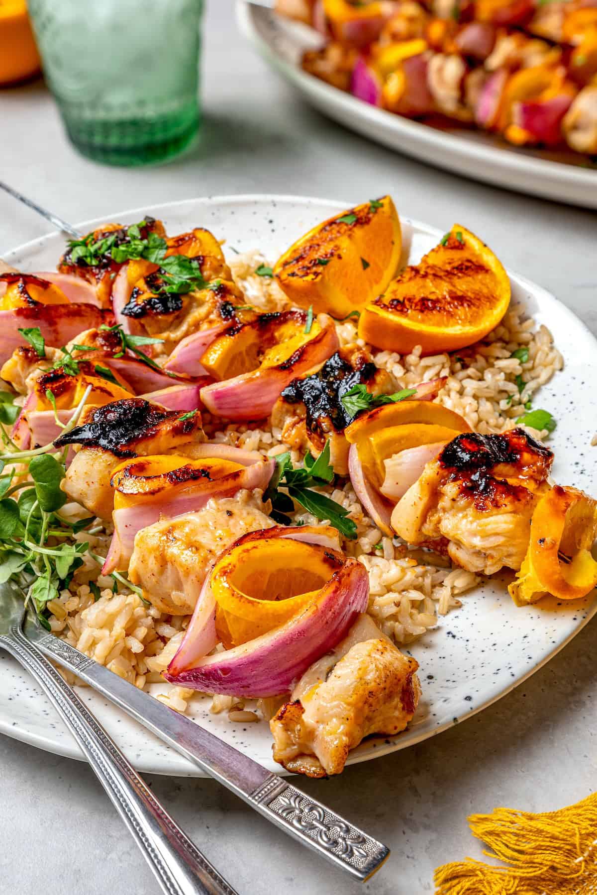 Bold, smoky chipotle meets the sweet flavor of orange in these easy Turkey Kabobs. This recipe is a summer staple in my home! Plate of grilled chipotle orange turkey kabobs with rice