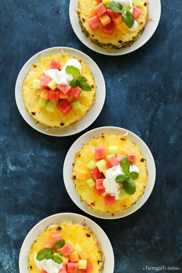 Pineapple Fruit Salad with Honey Vanilla Bean Yogurt Dressing on a blue table