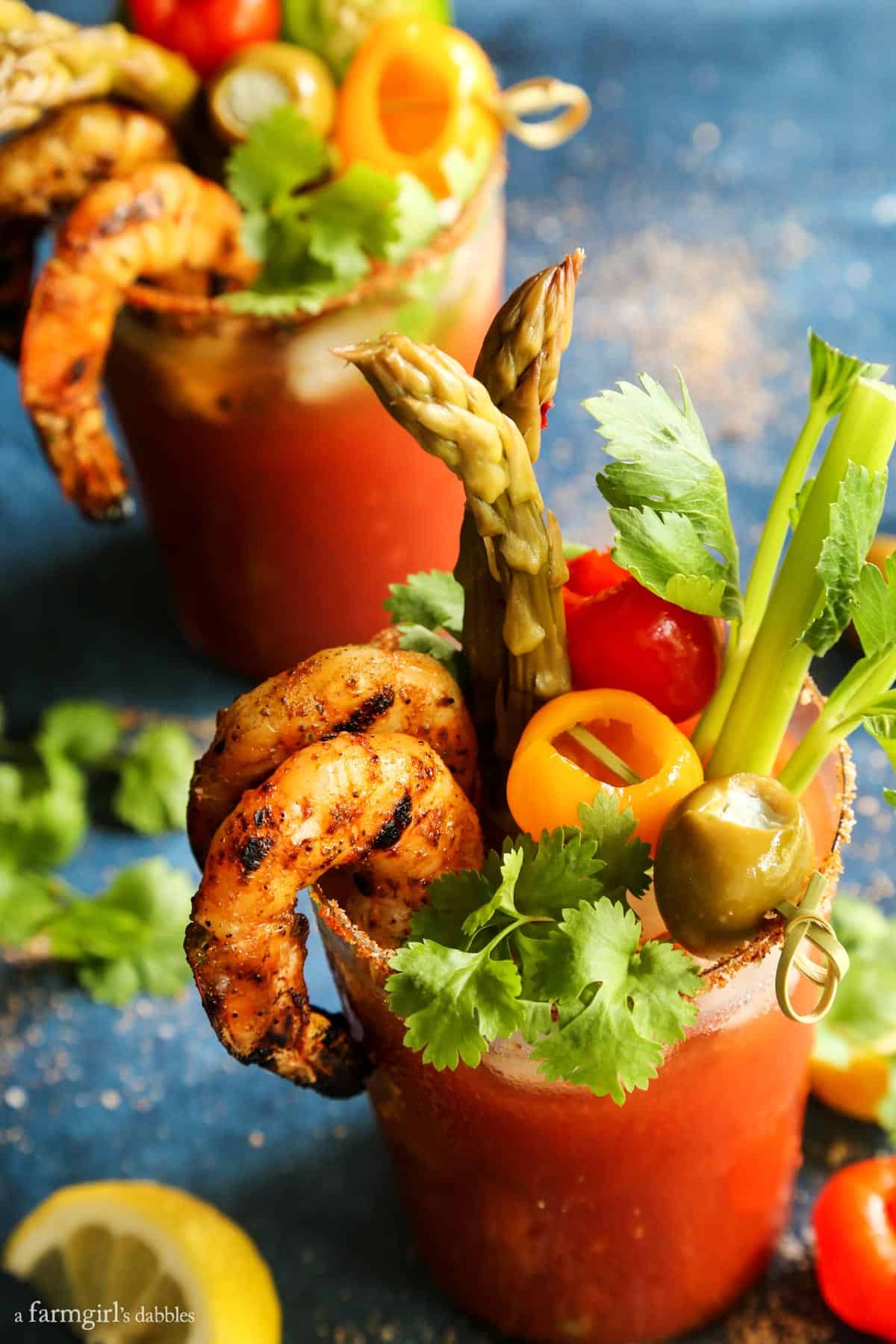 A bloody mary rimming salt recipe to elevate your brunch game. Add extra flavor and pretty texture to your cocktail with a salted rim! 5 Pepper Bloody Mary with Grilled Jalapeño Shrimp in a glass.
