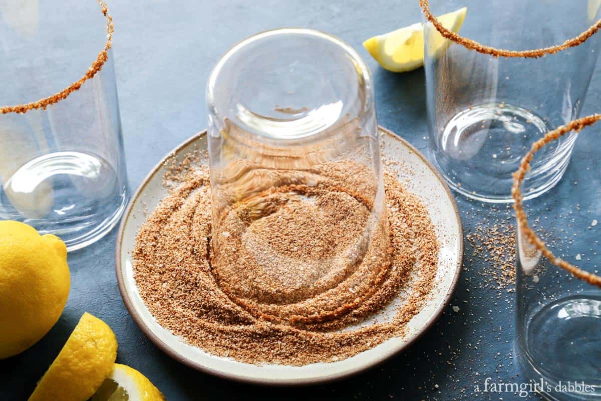 A bloody mary rimming salt recipe to elevate your brunch game. Add extra flavor and pretty texture to your cocktail with a salted rim! Bloody Mary Rim Salt on a plate.