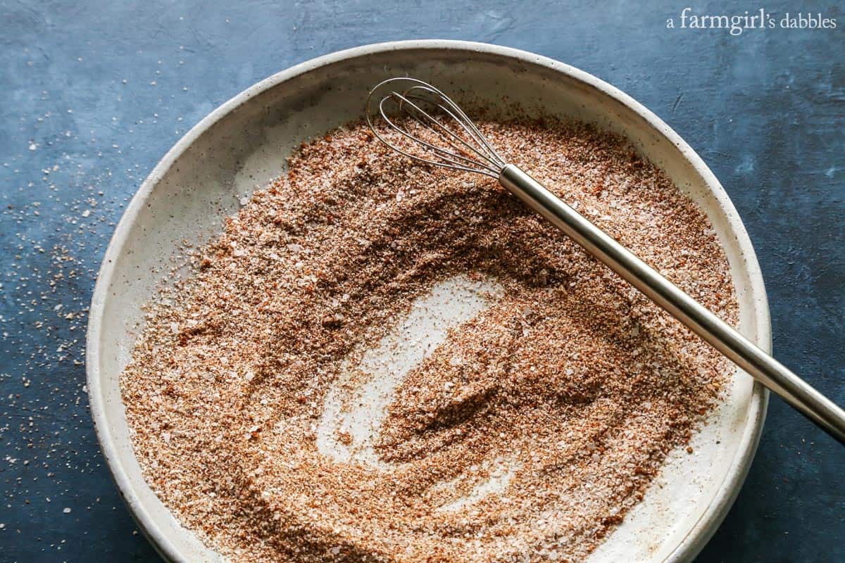 A bloody mary rimming salt recipe to elevate your brunch game. Add extra flavor and pretty texture to your cocktail with a salted rim! rim salt and a small whisk on a plate