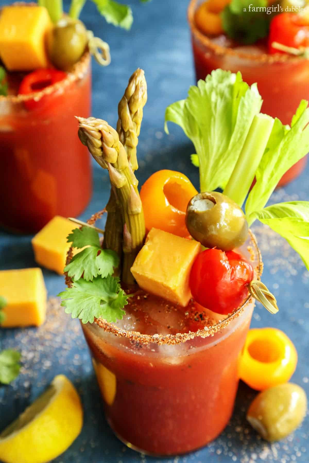 A bloody mary rimming salt recipe to elevate your brunch game. Add extra flavor and pretty texture to your cocktail with a salted rim! Three glasses of Bloody Mary cocktail.