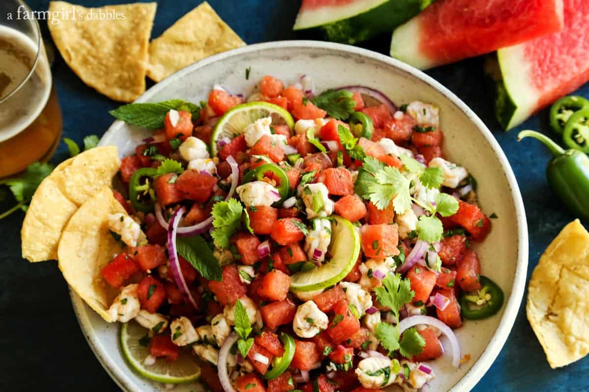 This watermelon and citrus shrimp ceviche recipe is loaded with nuggets of fresh shrimp, plus the bright flavors of orange and lime! Watermelon and Shrimp Ceviche in a white pottery bowl