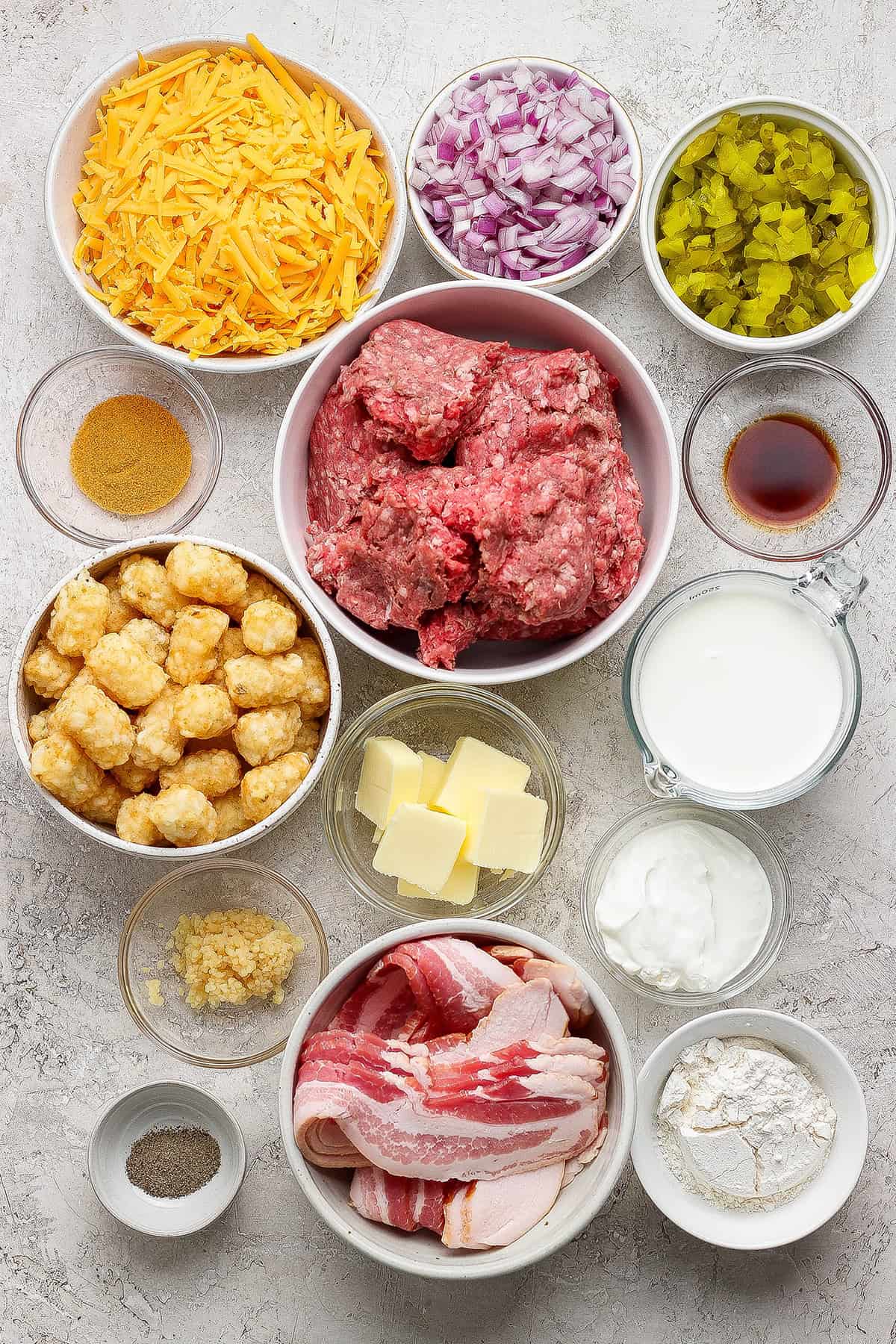 Crispy tater tots, ground beef, smoky bacon and cheese make this bacon cheeseburger tater tot casserole taste like a burger in hot dish form! Ingredients for bacon cheeseburger tater tot casserole.