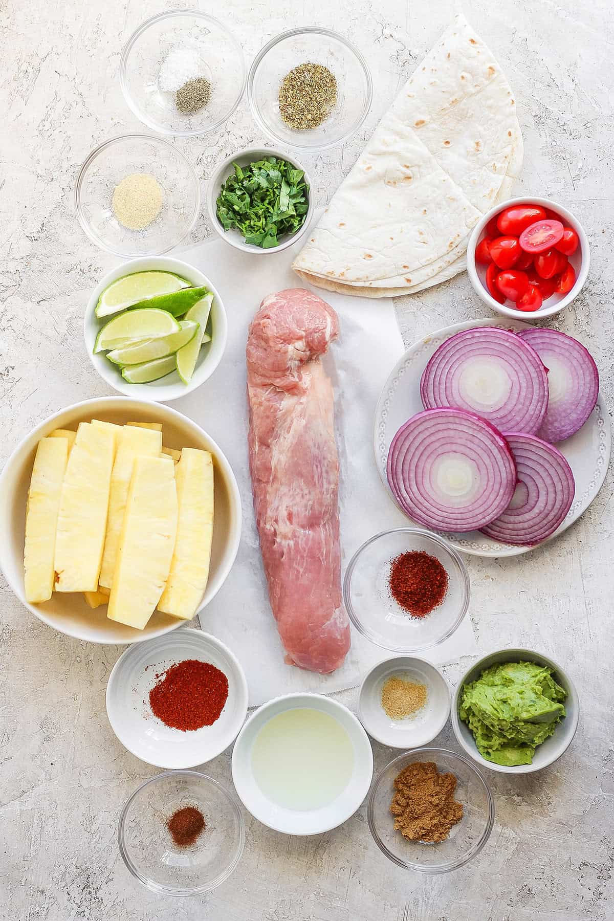This Grilled Pork and Pineapple Tacos recipe a much easier twist on tacos al pastor. It promises to be your next taco night hit! Overhead view of ingredients for grilled pork and pineapple tacos