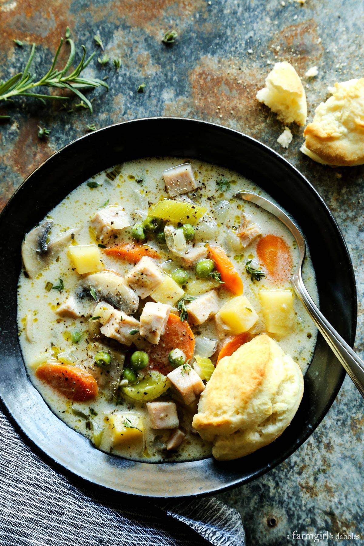 Smoked Turkey Pot Pie Soup is full of rich flavors and creamy comfort, and served with ultra-tender cream biscuits for dipping! Smoked Turkey Pot Pie Soup in a pottery bowl with fresh biscuits