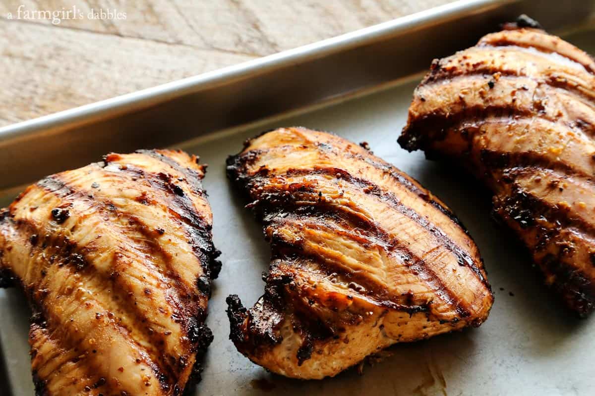 Tender, flavorful, and easy to make this Grilled Turkey Tenderloin with Brown Sugar and Whole Grain Mustard is a simple but elegant dinner. grilled turkey tenderloins on a rimmed sheet pan