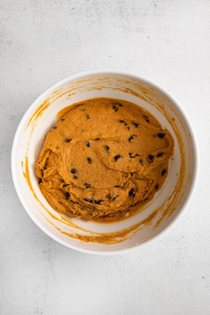 Muffin batter with chocolate chips in a large bowl.