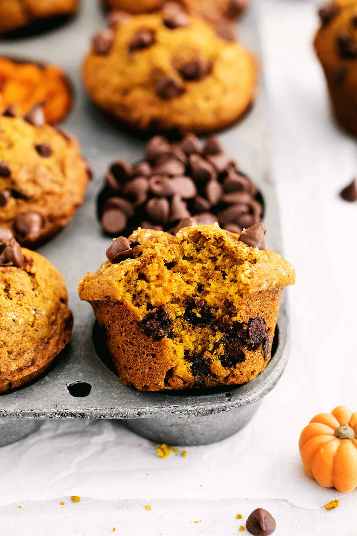 This fluffy pumpkin chocolate chip muffins recipe with warm spices will be your go-to baking project for a lovely fall brunch. Bitten into pumpkin muffin studded with melty chocolate chips.