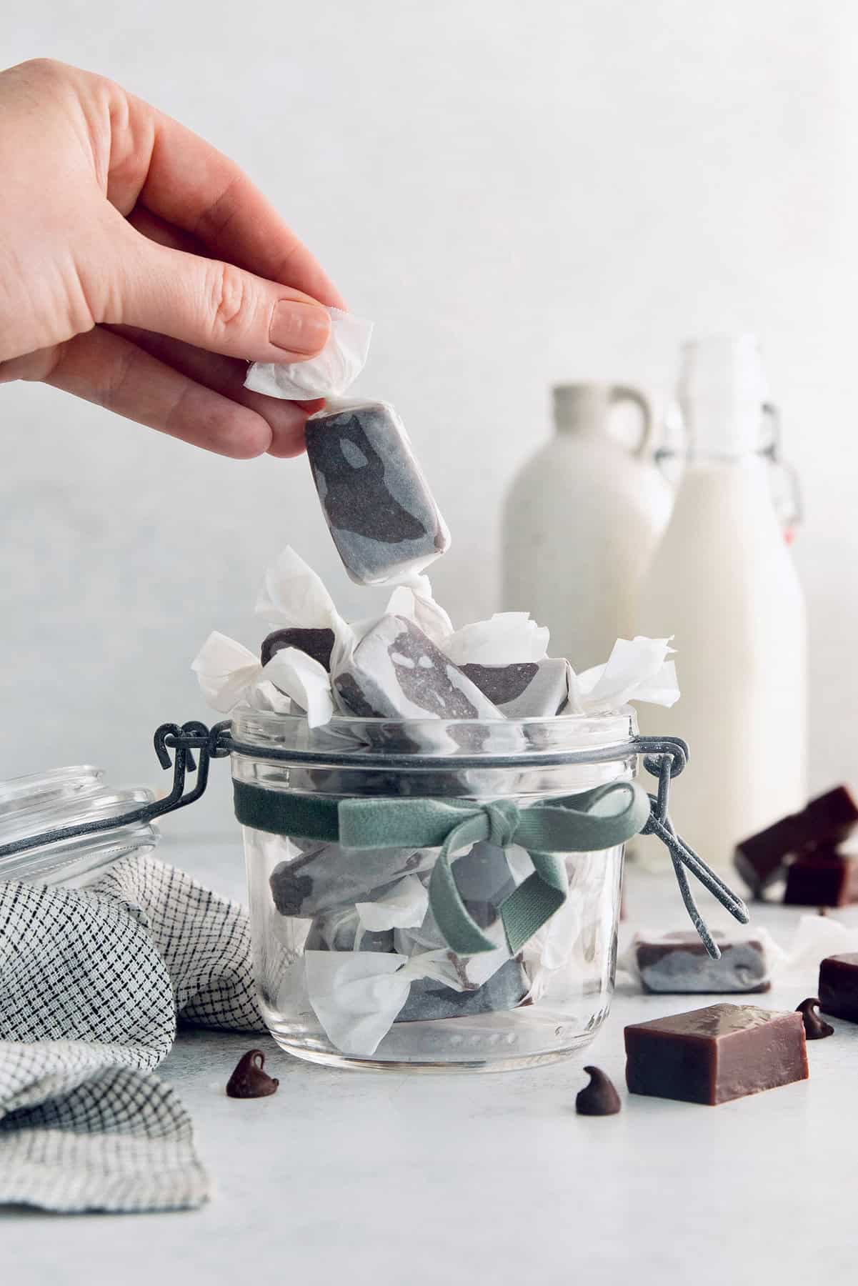 Grabbing a homemade caramel from the jar of wrapped candies. 