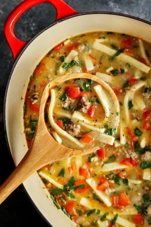 Hearty and satisfying, this Sausage and Red Pepper Soup with Egg Noodles is packed with comfort and delicious flavor! Sausage and Red Pepper Soup with Egg Noodles in a red pot