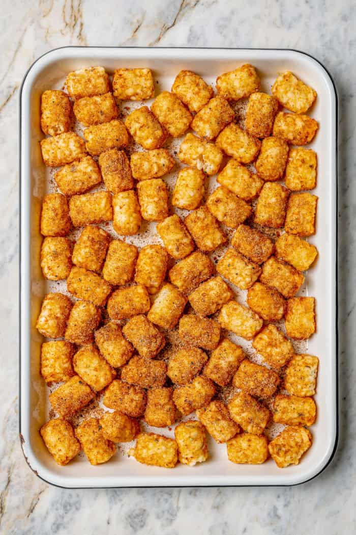 Seasoned tater tots on baking sheet