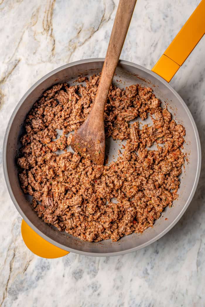 Overhead view of cooked ground beef mixture in skillet