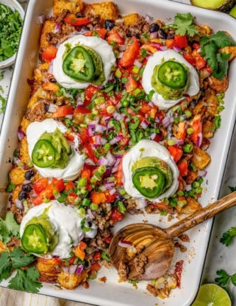 Overhead view of totchos in pan with wooden serving spoon