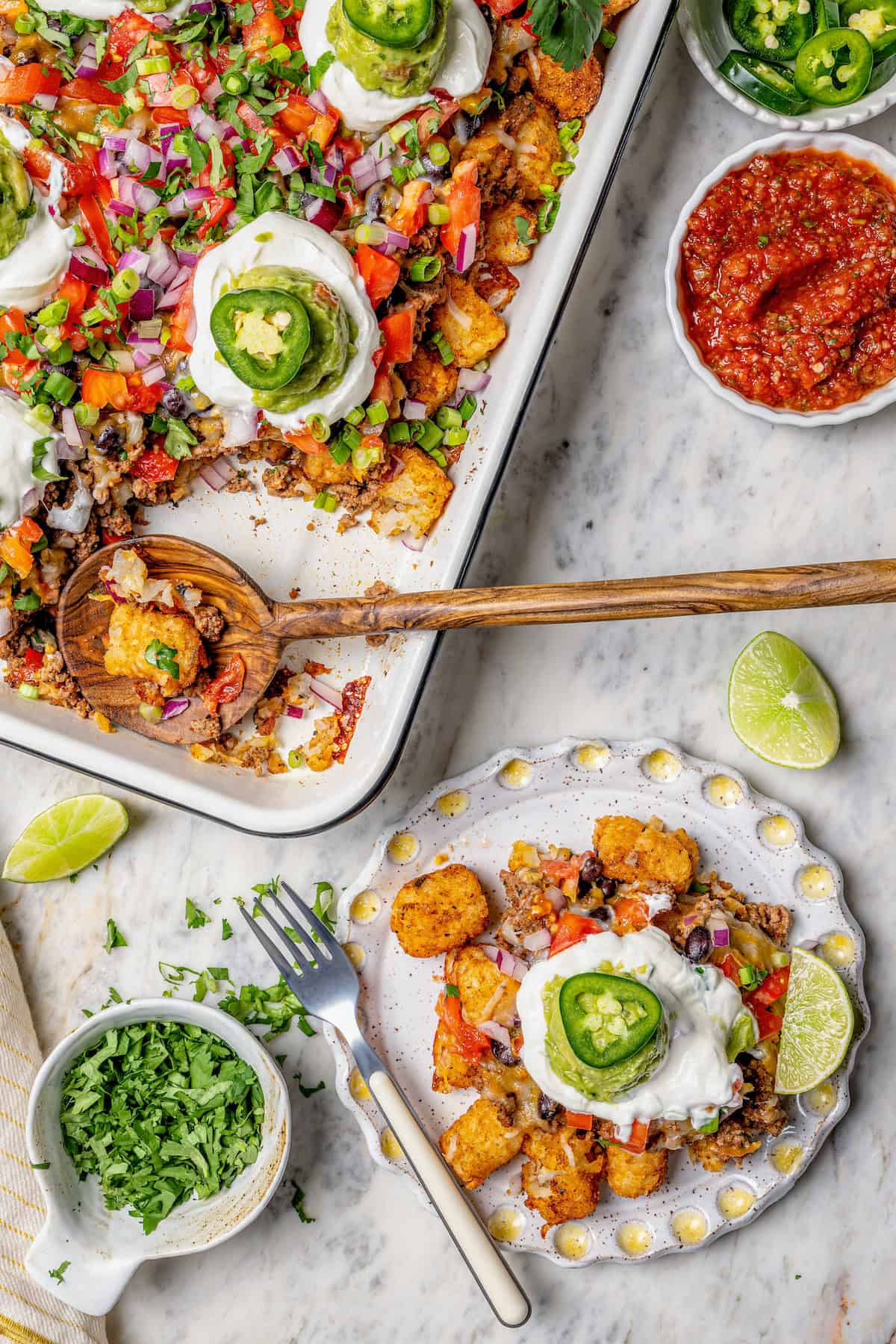 Overhead view of totchos on sheet pan and plate