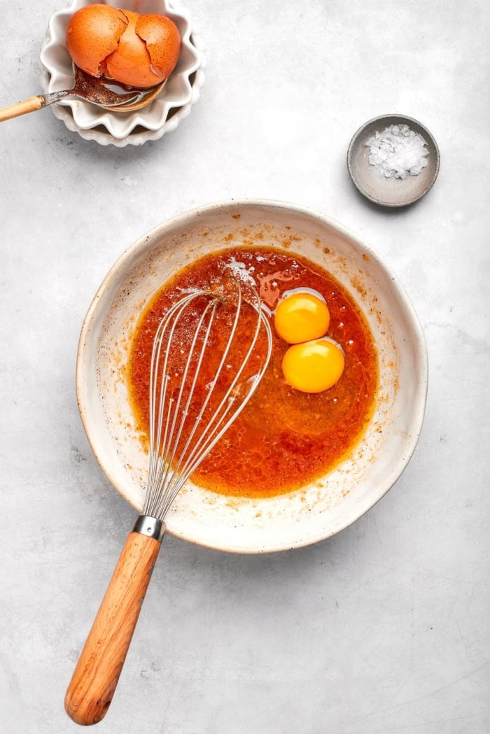 Nutty brown butter, flaky sea salt and fluffy buttercream make this chewy chocolate chip skillet cookie worthy of a celebration. So easy too! Whisking egg yolks into wet ingredients for skillet cookie.