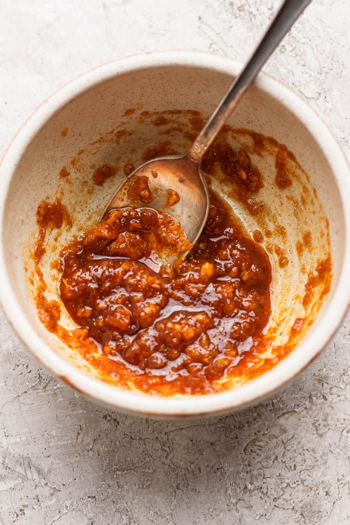 Grilled Chipotle-Orange Salmon is sweet, smoky and just a bit spicy, with irresistible caramelized edges. An easy recipe that feels special! Chipotle-orange glaze in bowl with spoon