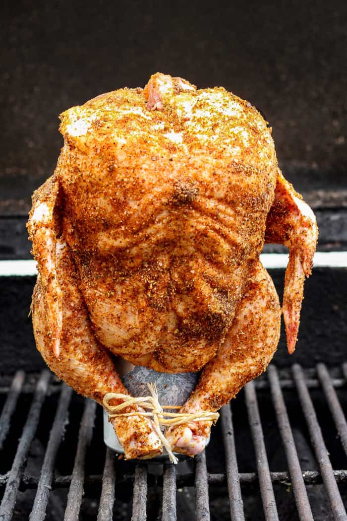 This easy Beer Can Chicken Recipe guarantees moist meat and crispy, flavorful skin. It’s our go-to recipe for a grilled whole chicken! Beer can chicken standing on can set on grill