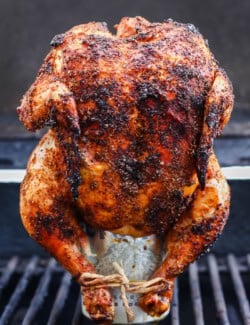 Cooked beer can chicken standing on can set on grill