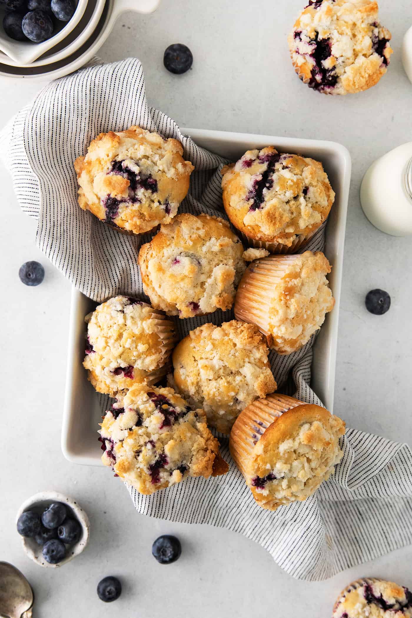 Soft, fluffy, and filled with blueberries, this family recipe makes a batch of the best blueberry muffins topped with a buttery streusel. Overhead view of moist blueberry muffins in a pan