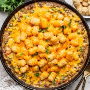 Overhead view of tater tot hotdish in cast iron skillet
