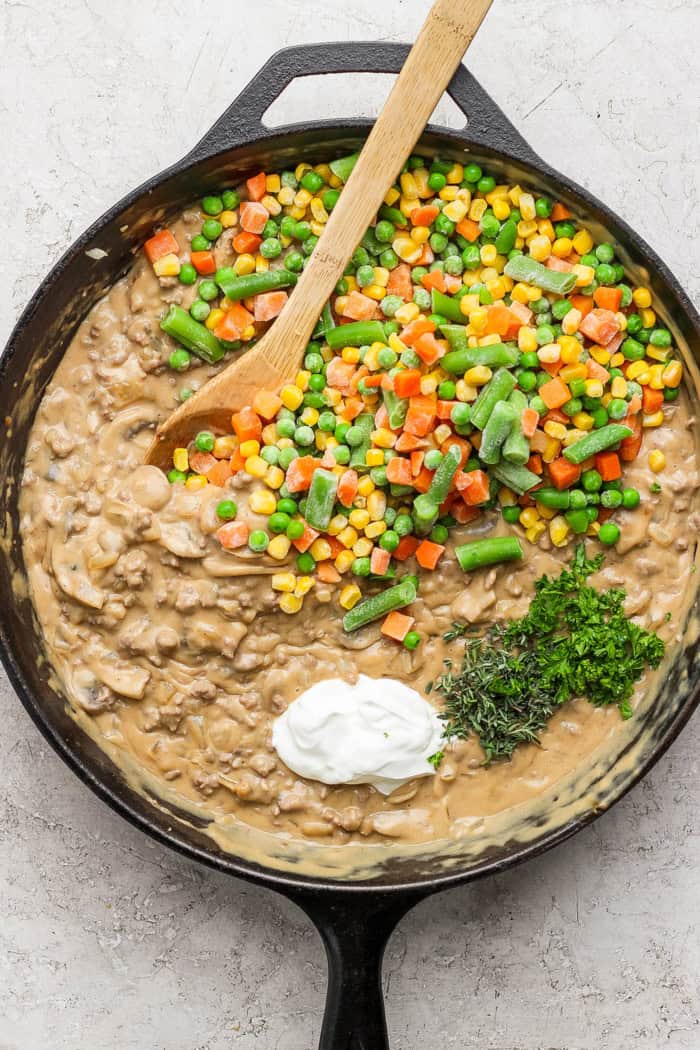 My easy made-from-scratch Tater Tot Hotdish is classic Minnesota comfort food — but fear not, I also share a canned soup version too! Stirring sour cream, herbs, and frozen mixed vegetables into hotdish filling