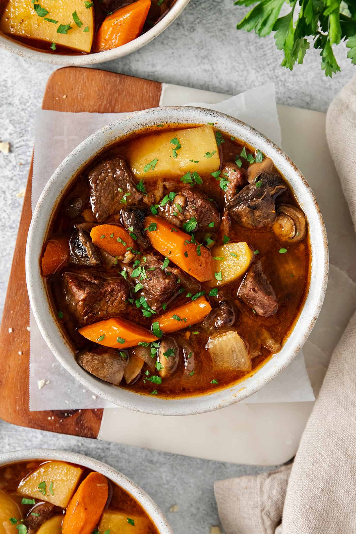 Slow Cooker Hungarian Goulash loaded with chunks of tender, melt-in-your-mouth beef and vegetables. Authentic, easy comfort food at its best! Overhead view of a bowl of Hungarian goulash
