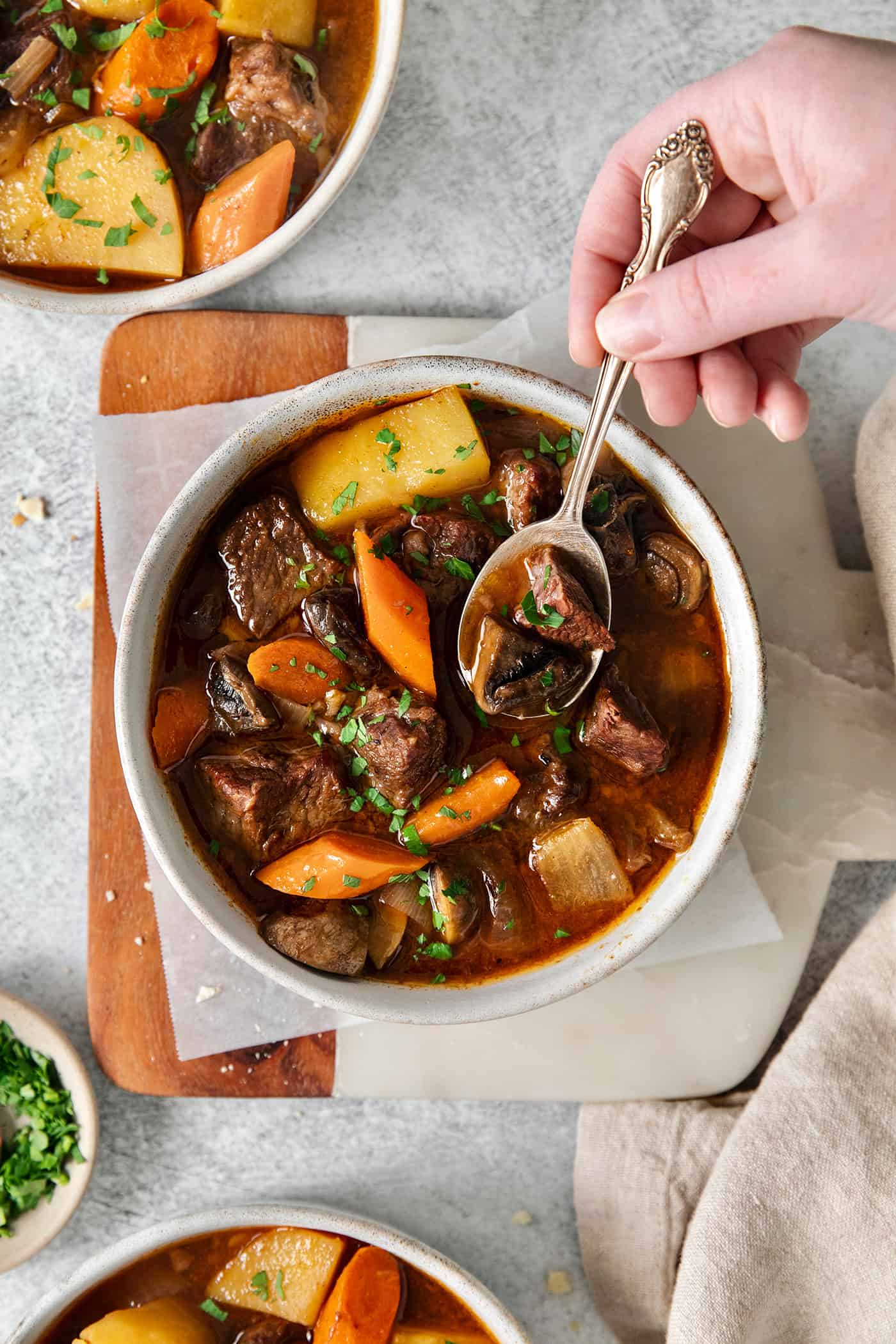 Slow Cooker Hungarian Goulash loaded with chunks of tender, melt-in-your-mouth beef and vegetables. Authentic, easy comfort food at its best! A spoon over a bowl of goulash