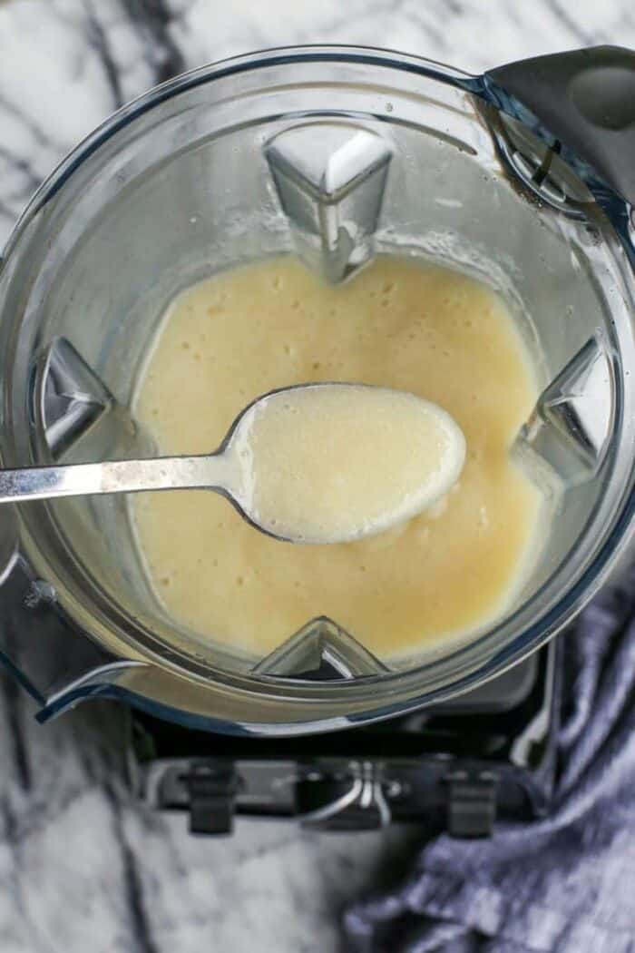 Extra cheesy and creamy, this broccoli cheddar soup recipe is loaded with all kinds of wholesome veggies. Don't forget a sprinkle of bacon! A spoonful held over blended potatoes and caulfilower in a blender.
