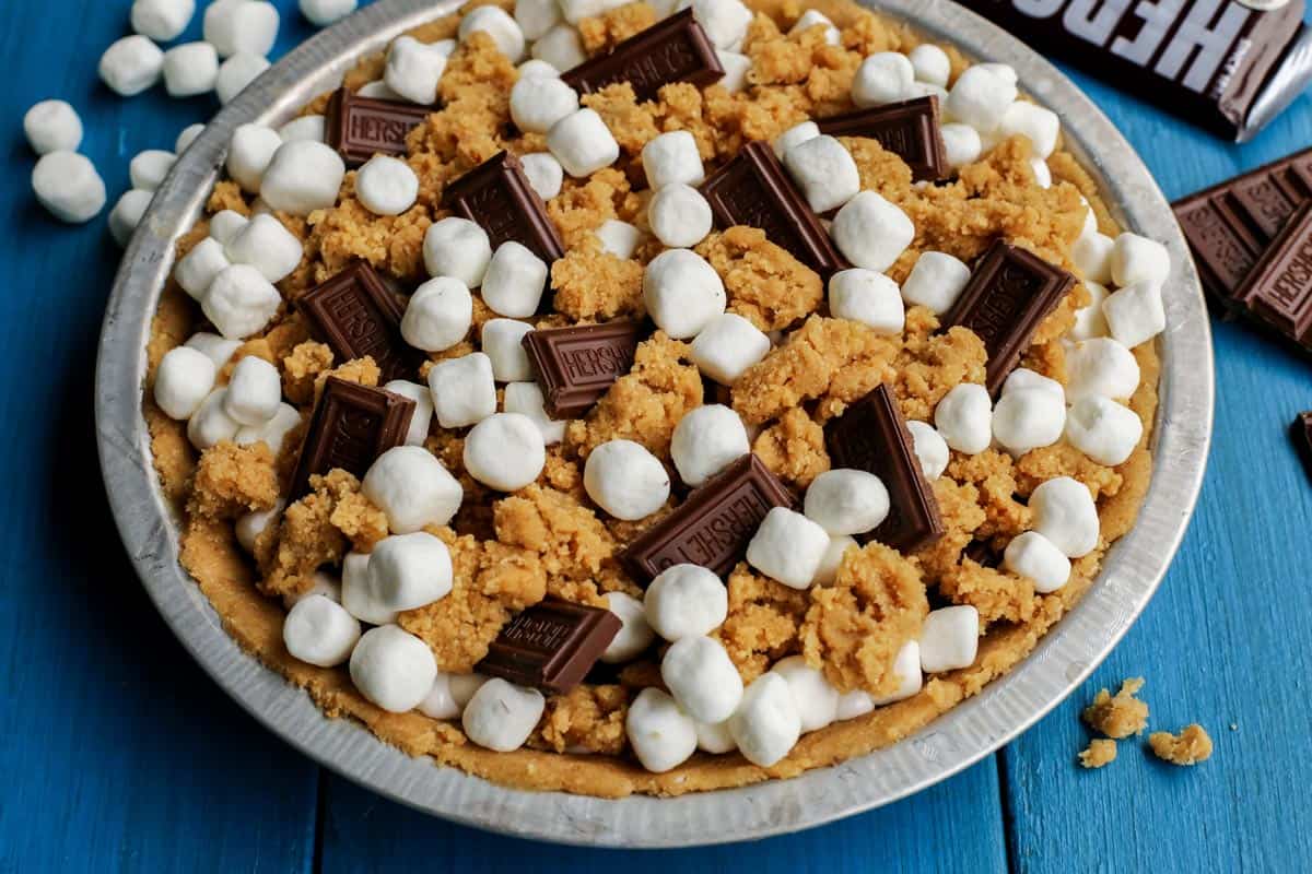 Gooey, chocolatey, and utterly delicious, this S'mores Pie allows you to enjoy the flavors of the classic summertime treat any time of the year. No campfire required! S'mores Pie with chocolate bars