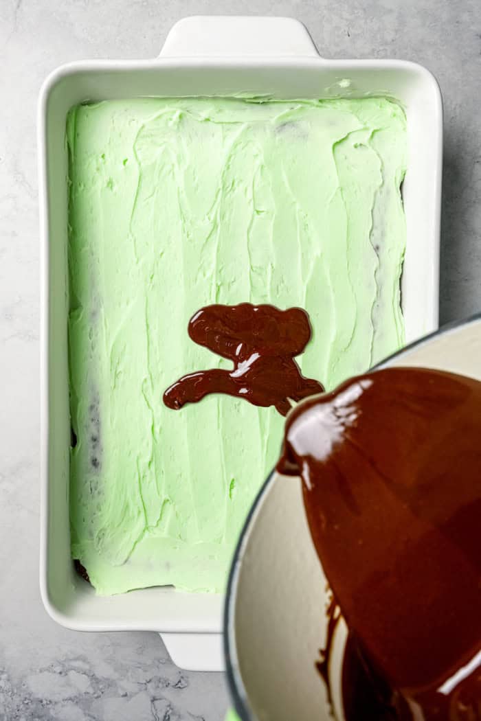 Pouring glaze onto brownies